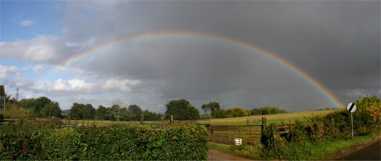 Strong autumn shower rainbow